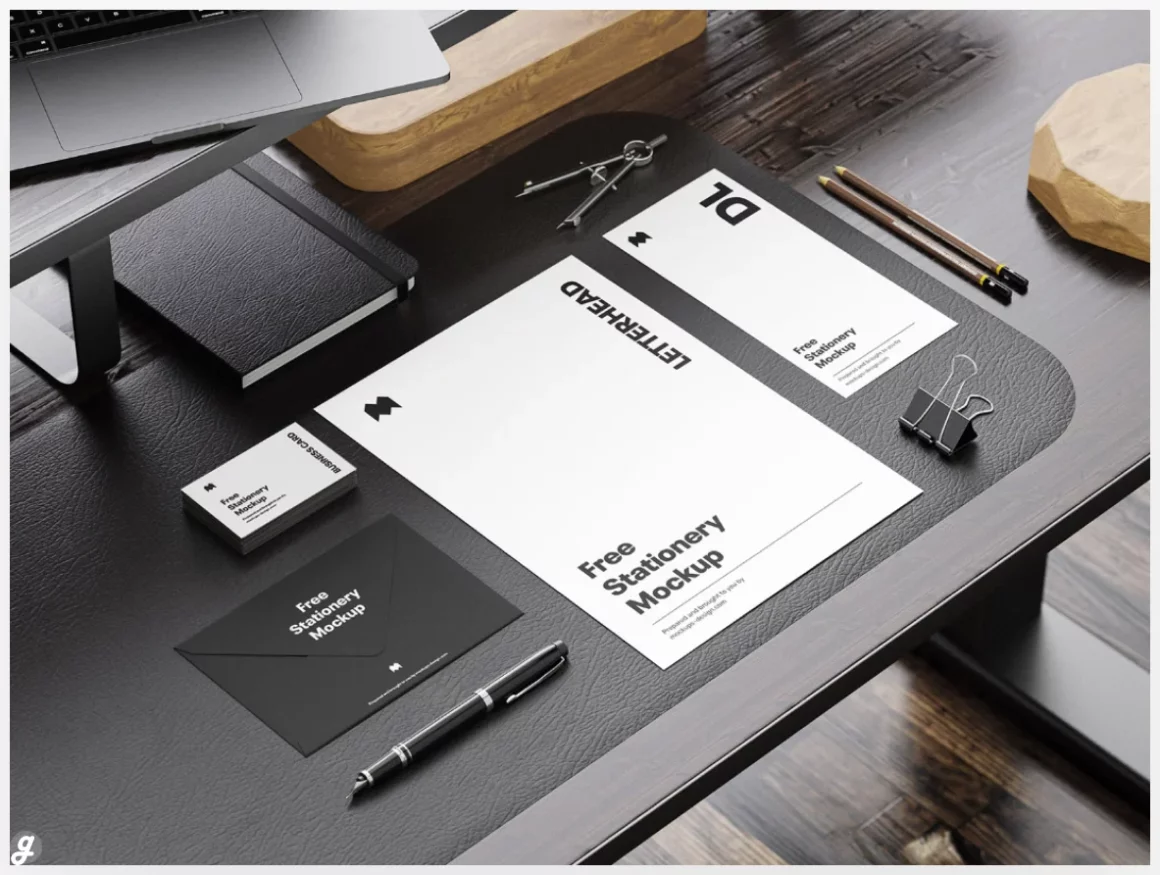 Stationery on the wooden desk mockup