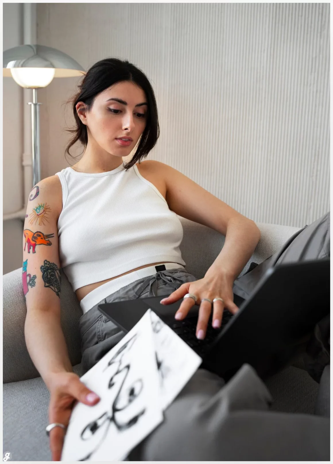 Braless woman working indoor with Arm Tattoo Mockup